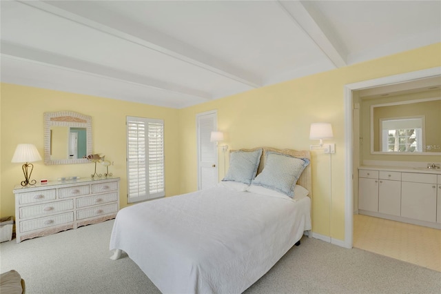 2 Antigua Cir Unit 4, Englewood, FL 34223 - bedroom with beamed ceiling, a sink, and light colored carpet