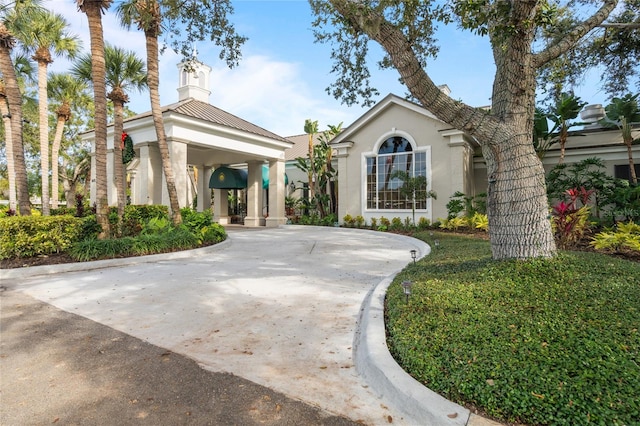2 Antigua Cir Unit 4, Englewood, FL 34223 - view of front facade featuring metal roof, driveway, and stucco siding