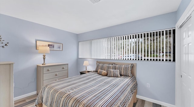 bedroom featuring baseboards and light wood-style floors