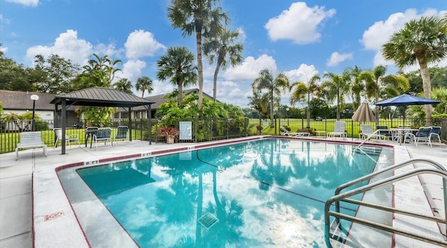 pool featuring a gazebo, a patio, and fence