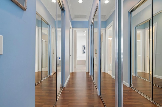 corridor featuring baseboards, dark wood-style flooring, crown molding, and recessed lighting