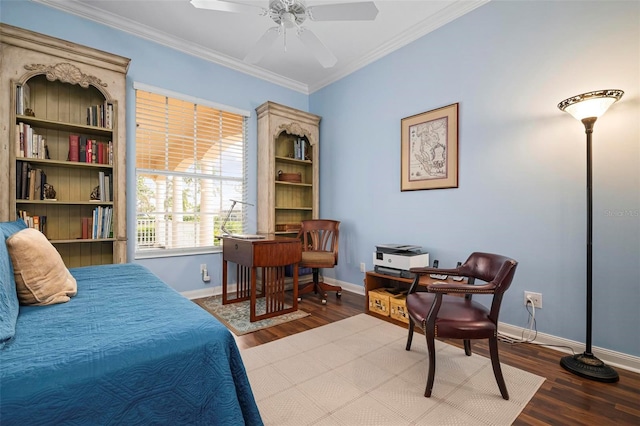 bedroom featuring baseboards, wood finished floors, and crown molding