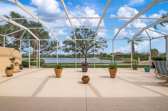 view of patio / terrace with a water view and a lanai