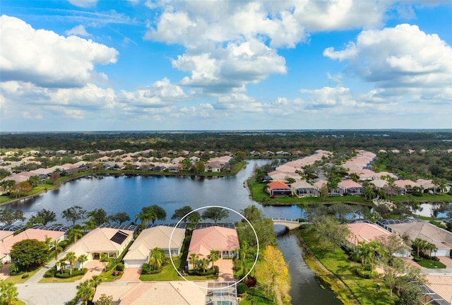 drone / aerial view with a water view and a residential view