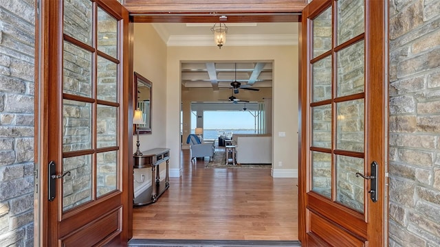 doorway to outside with french doors, beam ceiling, ornamental molding, wood finished floors, and coffered ceiling