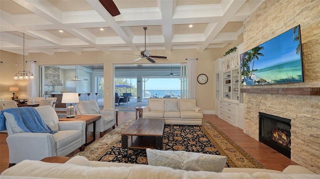 living room featuring baseboards, coffered ceiling, wood finished floors, beamed ceiling, and a fireplace