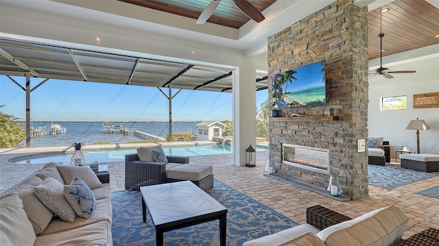 view of patio / terrace with an outdoor pool, ceiling fan, and an outdoor living space with a fireplace