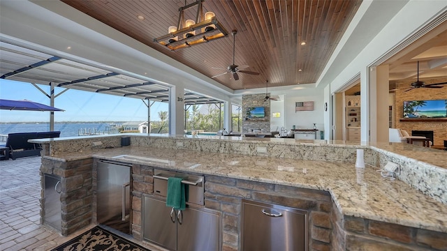 view of patio / terrace with glass enclosure, ceiling fan, and area for grilling