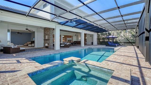 view of pool with a patio, glass enclosure, ceiling fan, a pool with connected hot tub, and an outdoor living space