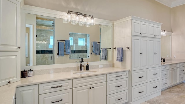 bathroom with ornamental molding, a shower stall, and vanity