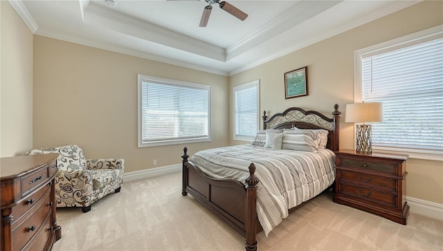 bedroom with light carpet, baseboards, ornamental molding, and a raised ceiling