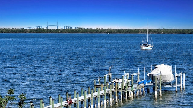 dock area with a water view and boat lift