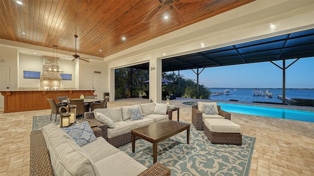 living room with wooden ceiling, a sunroom, and a ceiling fan