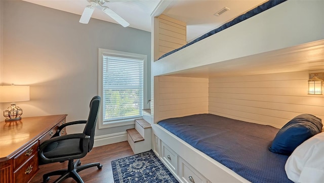 bedroom with baseboards, ceiling fan, visible vents, and dark wood-style flooring