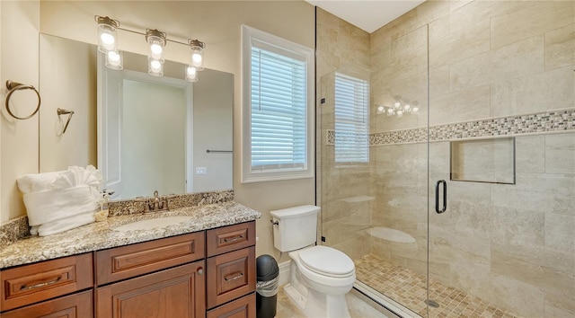 bathroom featuring a stall shower, vanity, and toilet