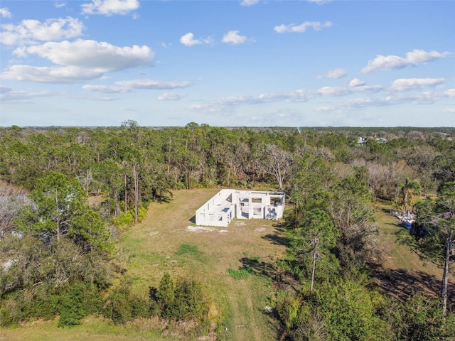 drone / aerial view featuring a forest view