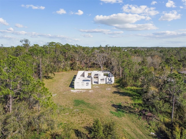 aerial view featuring a wooded view