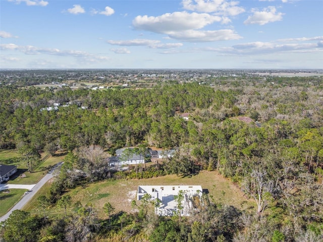 birds eye view of property with a forest view