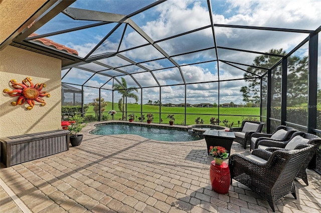 view of patio featuring a lanai and a pool with connected hot tub