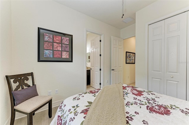 bedroom featuring a closet, connected bathroom, and baseboards