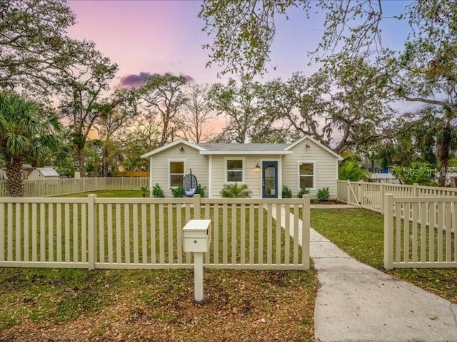 view of front of home with a fenced front yard and a front yard