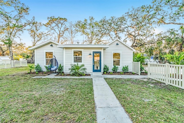 view of front of property featuring fence private yard and a front yard