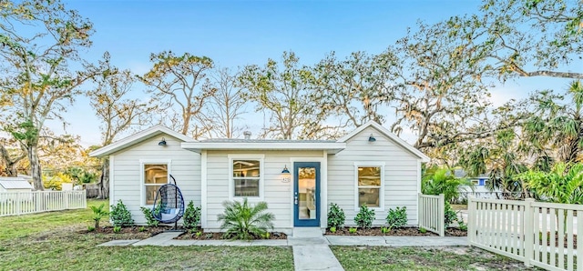 bungalow with fence and a front yard