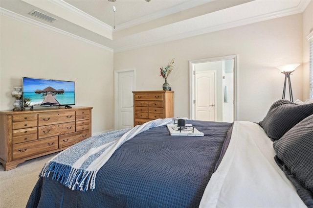 bedroom featuring crown molding, a tray ceiling, visible vents, and light colored carpet