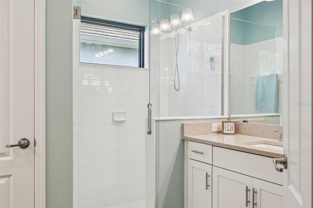 bathroom featuring a stall shower and vanity