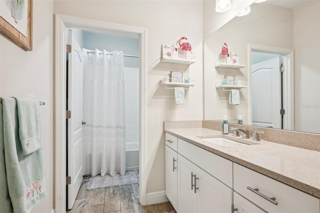 full bathroom with shower / bath combo with shower curtain, wood finished floors, and vanity