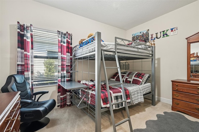 bedroom with carpet, a textured ceiling, and baseboards