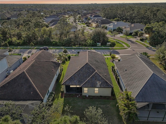 aerial view at dusk featuring a residential view