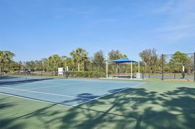 view of tennis court with fence