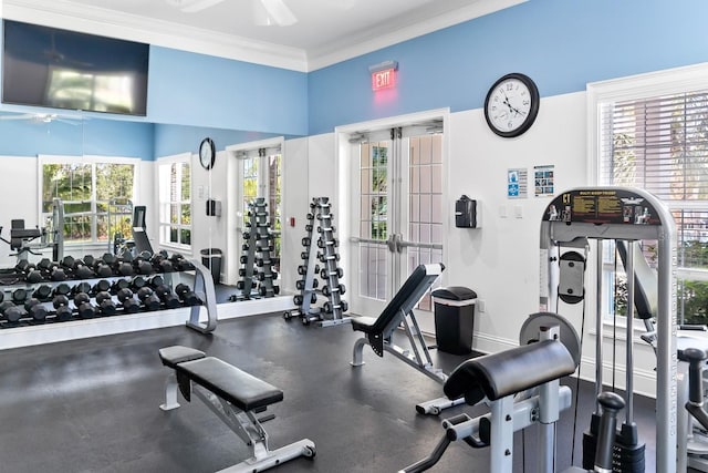 exercise room with a ceiling fan, crown molding, and baseboards