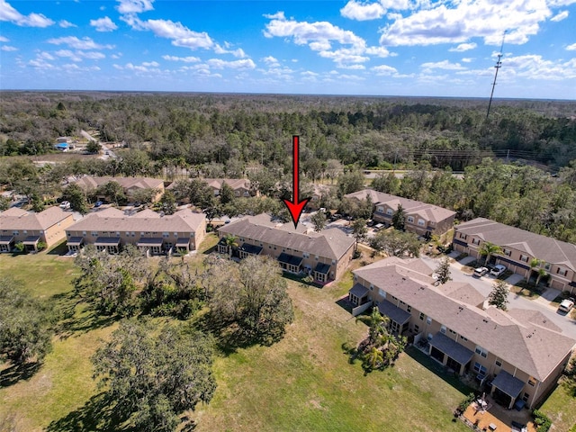 birds eye view of property featuring a residential view and a forest view