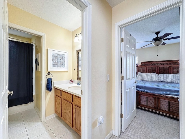 full bathroom featuring a textured ceiling, a ceiling fan, connected bathroom, and vanity