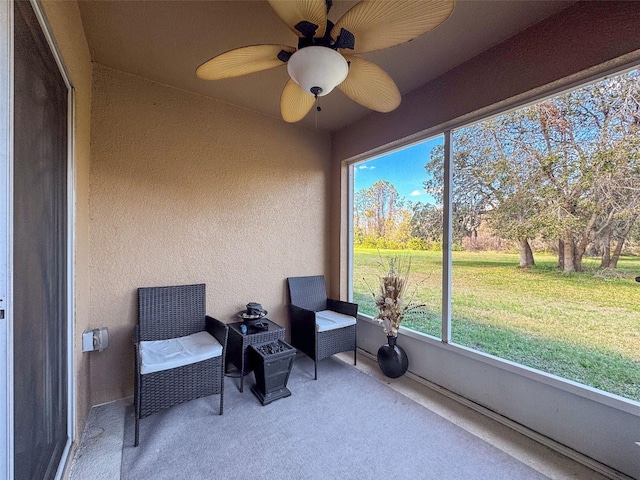 sunroom with a ceiling fan