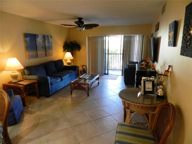 living room with light tile patterned floors, visible vents, and a ceiling fan