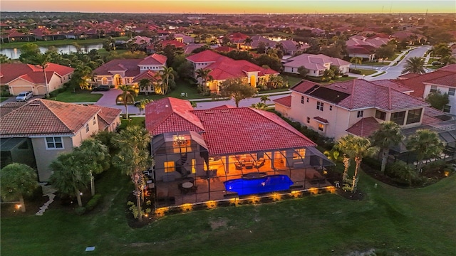 aerial view at dusk featuring a residential view