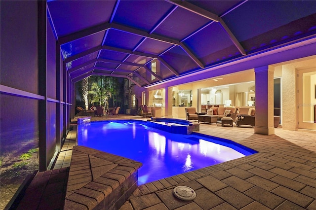 view of pool with a lanai, a patio area, and a pool with connected hot tub