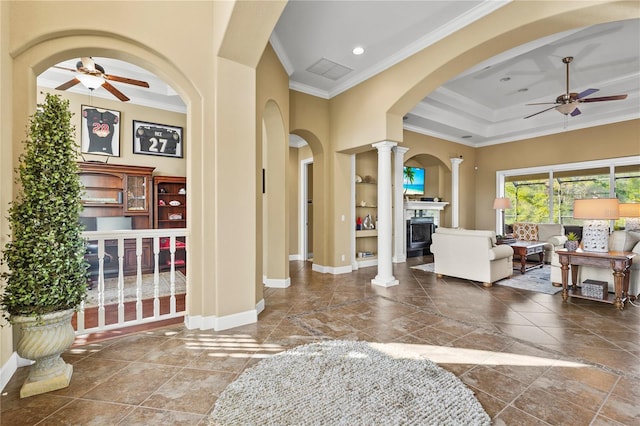 foyer with ceiling fan, ornamental molding, visible vents, and ornate columns