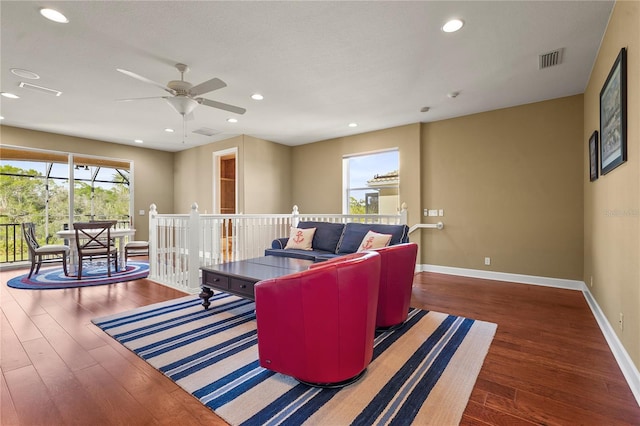 living area with recessed lighting, baseboards, visible vents, and hardwood / wood-style floors