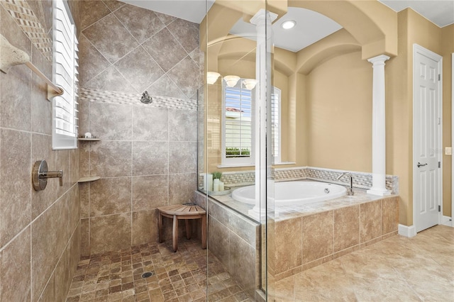 full bathroom with a garden tub, tile patterned floors, tiled shower, and ornate columns