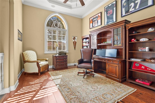 office space with baseboards, a ceiling fan, crown molding, and wood finished floors