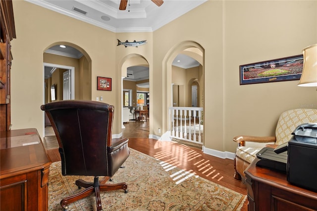 office with wood finished floors, a ceiling fan, baseboards, visible vents, and crown molding