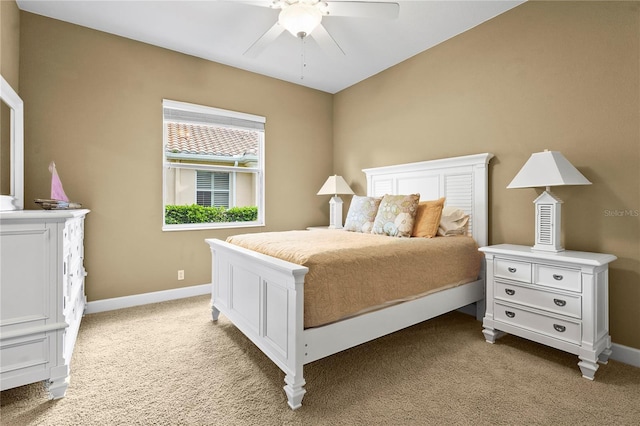 bedroom with light carpet, ceiling fan, and baseboards