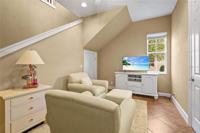 living area featuring light tile patterned flooring and baseboards