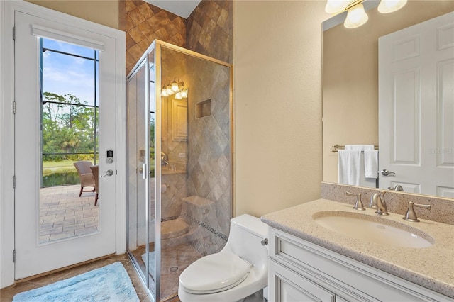 full bathroom featuring toilet, a stall shower, and vanity