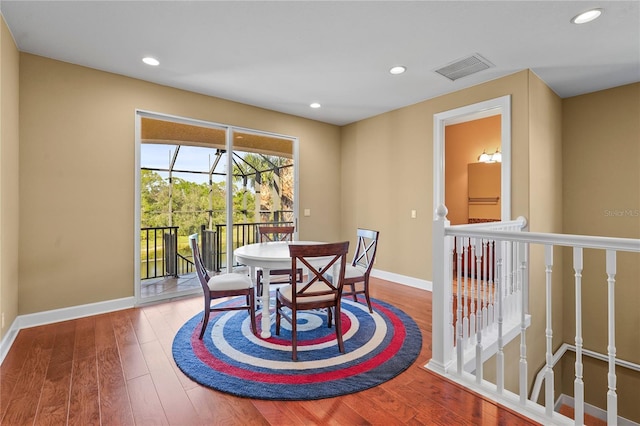 dining area featuring baseboards, visible vents, hardwood / wood-style floors, and recessed lighting