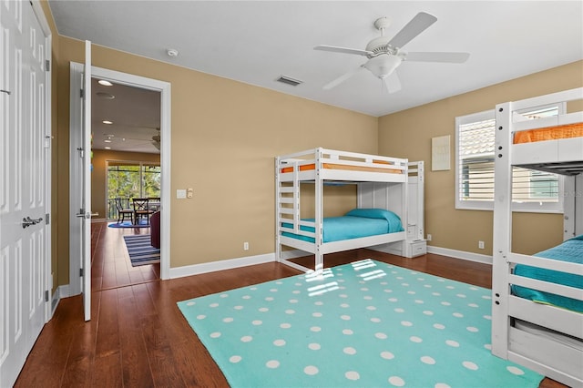 unfurnished bedroom featuring a ceiling fan, wood finished floors, visible vents, and baseboards